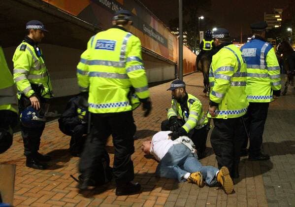 Poland - World Cup Qualifier . . Wembley, London . . 15.10.2013 A Polish fan is restrained by police outside Wembley Stadium. 