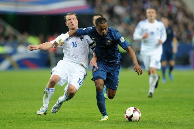 Patrice Evra (France) Teemu Tainio (Finlande) FOOTBALL : France vs Finlande- Quaifications CM2014 - 15 10 2013 N.LeGouic FEP Panoramic 