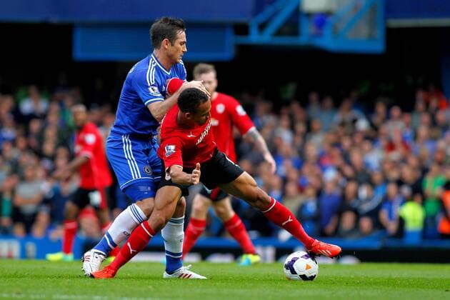 Football - 2013 2014 Premier League - Chelsea FC London vs Cardiff City Frank Lampard of Chelsea fouls Cardiff City s Peter Odemwingie at Stamford Bridge Colorsport Shaun Boggust 