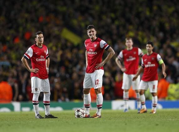 Arsenal s Mesut Ozil and Olivier Giroud look on dejected after going 2-1 down Arsenal v Dortmund - UEFA Champions League - the Emirates - London - England -22 10 2013 - Pic David Klein Sportimage EDITORIAL USE ONLY. No use with unauthorised audio, video, data, fixture lists, club league logos or live services. Online in-match use limited to 120 images, no video emulation. No use in betting, games or single club league player publications.