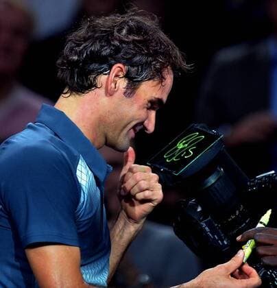 Roger Federer of Switzerland signs autograph on a camera after the quarterfinal match at the BNP Paribas 2013 Masters Tennis tournament in Paris, France, on Nov. 1, 2013. (Xinhua Chen Xiaowei) (SP)FRANCE-PARIS-ATP-BNP MASTERS TENNIS 