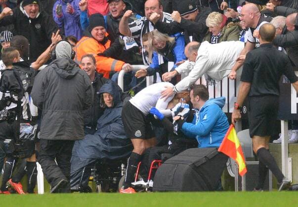 Loic Remy of Newcastle United celebrates with a disabled fan following the second goal - Barclays Premier League - Newcastle Utd vs Chelsea - St James Park Stadium - Newcastle - England - 02 11 13 - Picture Simon Bellis Sportimage EDITORIAL USE ONLY. No use with unauthorised audio, video, data, fixture lists, club league logos or live services. Online in-match use limited to 120 images, no video emulation. No use in betting, games or single club league player publications.