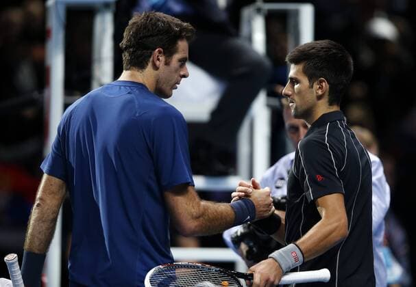 Novak Djokovic (R) of Serbia shakes hands with Juan Martin del Potro of Argentina after their Singles Group B match on day 4 of the Barclays ATP Tennis Herren World Tour Finals at the O2 Arena in London, Britain, Nov. 7, 2013. Novak Djokovic won 2-1. (Xinhua Wang Lili) (SP)BRITAIN-LONDON-TENNIS-ATP FINALS-SINGLES-GROUP B- 