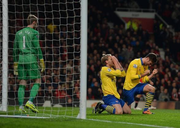 Nicklas Bendtner and Olivier Giroud of Arsenal react to a last minute chance to equalise - Barclays Premier League - Manchester United (ManU) vs Arsenal FC London - Old Trafford Stadium - Manchester - England - 10 11 13 - EDITORIAL USE ONLY. No use with unauthorised audio, video, data, fixture lists, club league logos or live services. Online in-match use limited to 120 images, no video emulation. No use in betting, games or single club league player publications.