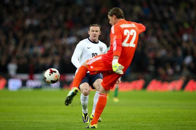England s Wayne Rooney puts pressure on Germany s Roman Weidenfeller - England v Germany - International Friendly - Wembley Stadium - London - 19th November 2013 - Pic Charlie Forgham-Bailey Sportimage EDITORIAL USE ONLY. No use with unauthorised audio, video, data, fixture lists, club league logos or live services. Online in-match use limited to 120 images, no video emulation. No use in betting, games or single club league player publications.