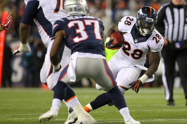 Denver Broncos running back Montee Ball (28) looks for running room on a carry in the second quarter against the New England Patriots in Foxboro, Massachusetts on November 24, 2013.  BOS2013112404