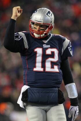 New England Patriots quarterback Tom Brady (12) pumps his fist after the Patriots scored on a one-yard carry by running back Brandon Bolden (not pictured) in the third quarter against the Denver Broncos in Foxboro, Massachusetts on November 24, 2013. The Patriots defeated the Broncos 34-31 in overtime.  BOS2013112409