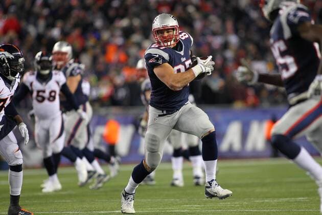 New England Patriots tight end Rob Gronkowski (87) charges up the field on a 15-yard reception in the fourth quarter against the Denver Broncos at Gillette Stadium in Foxboro, Massachusetts on November 24, 2013. The Patriots defeated the Broncos 34-31 in overtime.  BOS2013112418