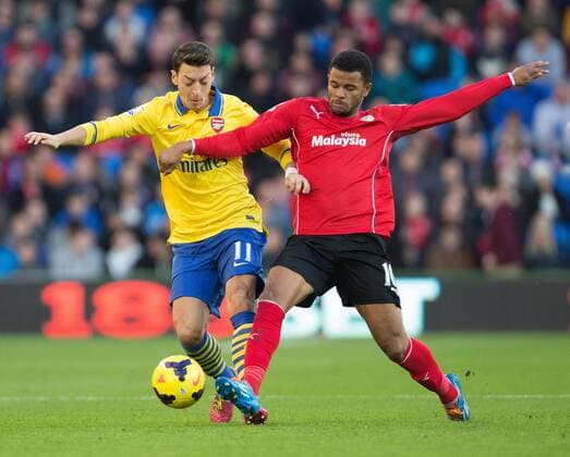 Cardiff s Fraizer Campbell dispossess Arsenal s Mesut Ozil - Cardiff City vs. Arsenal FC London - Barclays Premier League - Cardiff City Stadium - Cardiff - 30 11 2013 EDITORIAL USE ONLY. No use with unauthorised audio, video, data, fixture lists, club league logos or live services. Online in-match use limited to 120 images, no video emulation. No use in betting, games or single club league player publications.