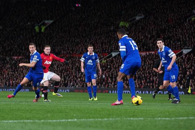 Wayne Rooney of Manchester United drills in a low shot but hits the post - Manchester United vs. Everton - Barclays Premier League - Old Trafford - Manchester - 04 12 2013 Pic Philip Oldham Sportimage EDITORIAL USE ONLY. No use with unauthorised audio, video, data, fixture lists, club league logos or live services. Online in-match use limited to 120 images, no video emulation. No use in betting, games or single club league player publications.