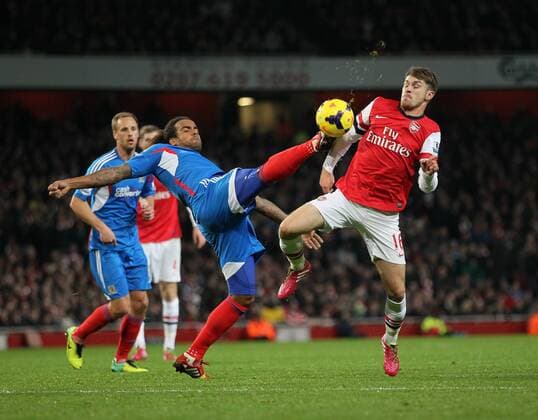 Arsenal s Aaron Ramsey tussles with Hull s Tom Huddlestone Arsenal v Hull City - Premier League - Emirates Stadium - London - 04 12 2013 - Pic David Klein Sportimage EDITORIAL USE ONLY. No use with unauthorised audio, video, data, fixture lists, club league logos or live services. Online in-match use limited to 120 images, no video emulation. No use in betting, games or single club league player publications.