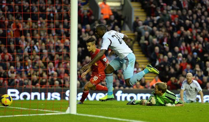 Guy Demel of West Ham United scores an own goal to put Liverpool in the lead 1-0 - Barclays Premier League - Liverpool vs West Ham Utd - Anfield Stadium - Liverpool - England - 7th December 2013 - Picture Simon Bellis Sportimage EDITORIAL USE ONLY. No use with unauthorised audio, video, data, fixture lists, club league logos or live services. Online in-match use limited to 120 images, no video emulation. No use in betting, games or single club league player publications.