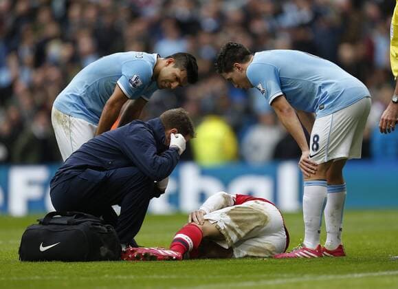 Manchester City s Sergio Kun Agüero and Samir Nasri look on concerned as Arsenal s Laurnet Koscielny gets injured Manchester City vs Arsenal - Premier League - Etihad Stadium - Manchester - England - 14 12 2013 - Pic David Klein Sportimage EDITORIAL USE ONLY. No use with unauthorised audio, video, data, fixture lists, club league logos or live services. Online in-match use limited to 120 images, no video emulation. No use in betting, games or single club league player publications.