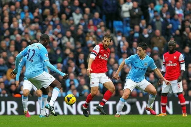 14.12.2013 Manchester, England. Yaya Toure of Manchester City and Samir Nasri clean up in front of Flamini during the Premier League game between Manchester City and Arsenal from the Etihad Stadium. xPaulxKeevilx  ActionPlus11479234