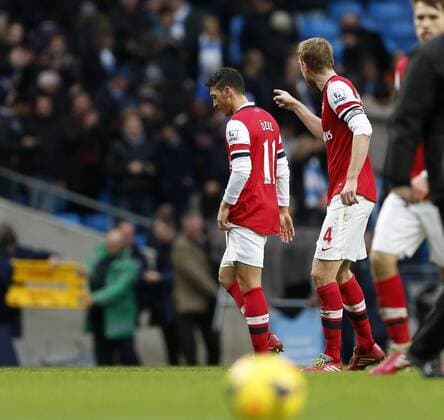 Arsenal s Mesut Ozil has an arguement with Per Mertesacker at the final whistle Manchester City vs Arsenal - Premier League - Etihad Stadium - Manchester - England - 14 12 2013 - EDITORIAL USE ONLY. No use with unauthorised audio, video, data, fixture lists, club league logos or live services. Online in-match use limited to 120 images, no video emulation. No use in betting, games or single club league player publications.