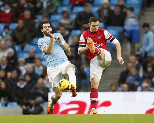 Manchester City s Alvaro Negredo tussles with Arsenal s Thomas Vermaelen Manchester City vs Arsenal - Premier League - Etihad Stadium - Manchester - England - 14 12 2013 - Pic David Klein Sportimage EDITORIAL USE ONLY. No use with unauthorised audio, video, data, fixture lists, club league logos or live services. Online in-match use limited to 120 images, no video emulation. No use in betting, games or single club league player publications.