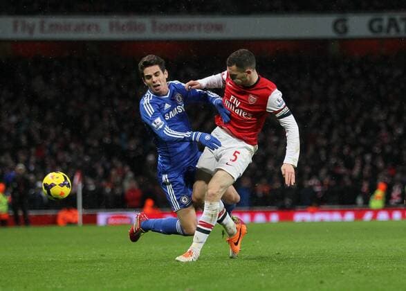 Arsenal s Thomas Vermaelen tussles with Chelsea s Oscar Arsenal FC London - Chelsea FC London. Premier League - Emirates Stadium - London - England - 23 12 2013 - xDavidxKleinxSportimagex EDITORIAL USE ONLY. No use with unauthorised audio, video, data, fixture lists, club league logos or live services. Online in-match use limited to 120 images, no video emulation. No use in betting, games or single club league player publications.