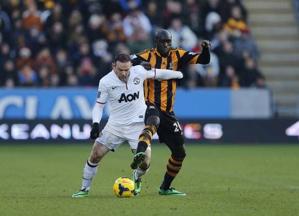 Hull City s Yannick Sagbo tussles with Manchester United s Wayne Rooney Hull City vs Manchester United - Premier League - KC Stadium - London - England - 26 12 2013 - Pic David Klein Sportimage EDITORIAL USE ONLY. No use with unauthorised audio, video, data, fixture lists, club league logos or live services. Online in-match use limited to 120 images, no video emulation. No use in betting, games or single club league player publications.
