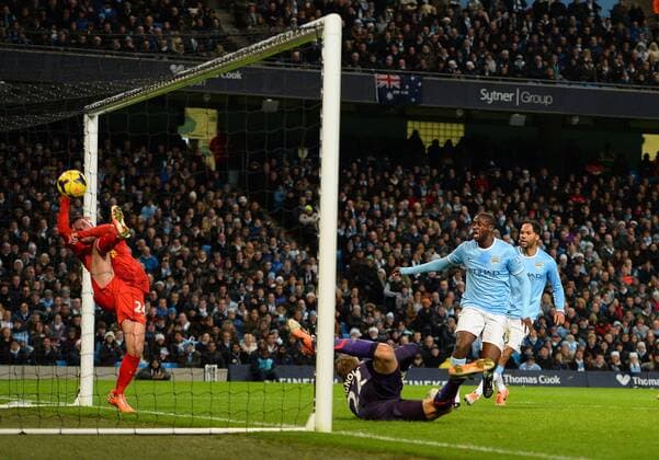 Yaya Toure of Manchester City looks on as Joe Allen of Liverpool tries to keep out a header from Vincent Kompany of Manchester City to equalise - Barclays Premier League - Manchester City vs Liverpool - Etihad Stadium - Manchester - England - 26th December 2013 - Picture Simon Bellis Sportimage EDITORIAL USE ONLY. No use with unauthorised audio, video, data, fixture lists, club league logos or live services. Online in-match use limited to 120 images, no video emulation. No use in betting, games or single club league player publications.