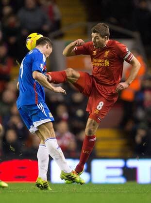 Steven Gerrard of Liverpool puts in a high tackle on Hull s James Chester - Liverpool vs. Hull City - Barclays Premier League - Anfield - Liverpool - 01 01 2014 Pic Philip Oldham Sportimage EDITORIAL USE ONLY. No use with unauthorised audio, video, data, fixture lists, club league logos or live services. Online in-match use limited to 120 images, no video emulation. No use in betting, games or single club league player publications.