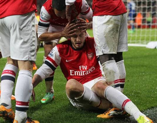 Arsenal s Nicklas Bendtner celebrates scoring his sides opening goal and then goes off injured having hurt his ankle - Arsenal FC London vs Cardiff City - Premier League - Emirates Stadium- London - England - 01 01 2014 - EDITORIAL USE ONLY. No use with unauthorised audio, video, data, fixture lists, club league logos or live services. Online in-match use limited to 120 images, no video emulation. No use in betting, games or single club league player publications.