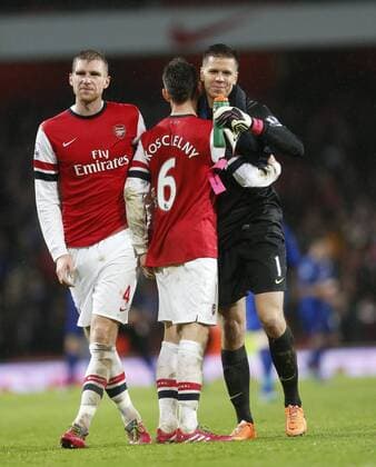 Arsenal s Per Mertesacker celebrates at the final whistle with Laurent Koscielny and Wojiech Szczesny Arsenal vs Cardiff - Premier League - Emirates Stadium- London - England - 01 01 2014 - Pic David Klein Sportimage EDITORIAL USE ONLY. No use with unauthorised audio, video, data, fixture lists, club league logos or live services. Online in-match use limited to 120 images, no video emulation. No use in betting, games or single club league player publications.