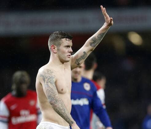 Arsenal s Jack Wilshere shows off his tattoos at the final whistle Arsenal vs Cardiff - Premier League - Emirates Stadium- London - England - 01 01 2014 - Pic David Klein Sportimage EDITORIAL USE ONLY. No use with unauthorised audio, video, data, fixture lists, club league logos or live services. Online in-match use limited to 120 images, no video emulation. No use in betting, games or single club league player publications.