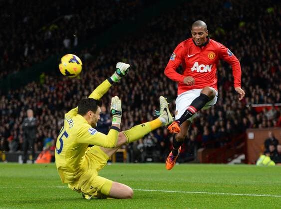 Hugo Lloris of Tottenham takes out Ashley Young of Manchester United but no penalty is given - Barclays Premier League - Manchester Utd vs Tottenham - Old Trafford Stadium - Manchester - England - 1st January 2014 - Picture Simon Bellis Sportimage EDITORIAL USE ONLY. No use with unauthorised audio, video, data, fixture lists, club league logos or live services. Online in-match use limited to 120 images, no video emulation. No use in betting, games or single club league player publications.