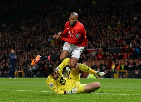 Hugo Lloris of Tottenham takes out Ashley Young of Manchester United but no penalty is given - Barclays Premier League - Manchester Utd vs Tottenham - Old Trafford Stadium - Manchester - England - 1st January 2014 - Picture Simon Bellis Sportimage EDITORIAL USE ONLY. No use with unauthorised audio, video, data, fixture lists, club league logos or live services. Online in-match use limited to 120 images, no video emulation. No use in betting, games or single club league player publications.