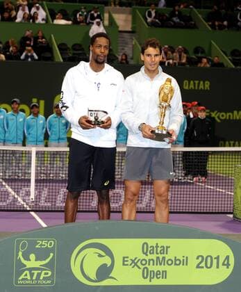 Rafael Nadal (R) of Spain and Gael Monfils of France pose during the awarding ceremony after their men s singles final in Qatar Open tennis tournament, Jan. 4, 2014. Nadal won 2-1 to claim the champion. (Xinhua Chen Shaojin) (SP)QATAR-DOHA-TENNIS-MEN 