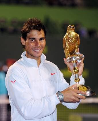Rafael Nadal of Spain poses with the trophy during the awarding ceremony after the men s singles final in Qatar Open tennis tournament, Jan. 4, 2014. Nadal won 2-1 to claim the champion. (Xinhua Chen Shaojin) (SP)QATAR-DOHA-TENNIS-MEN 