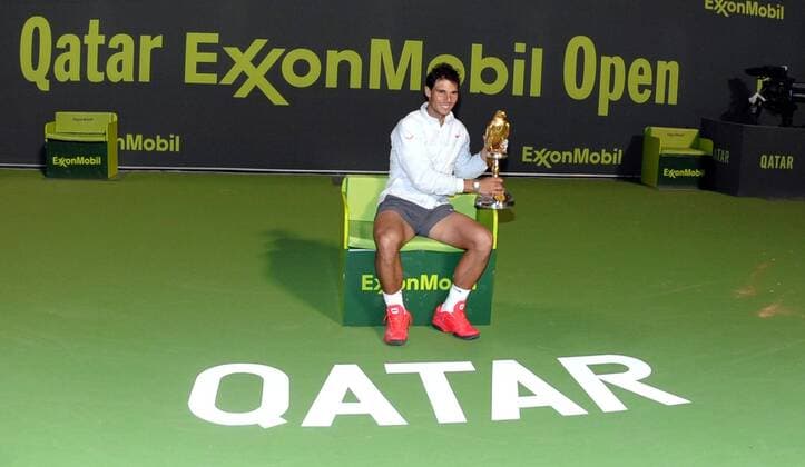 Rafael Nadal of Spain poses with the trophy during the awarding ceremony after the men s singles final in Qatar Open tennis tournament, Jan. 4, 2014. Nadal won 2-1 to claim the champion. (Xinhua Chen Shaojin) (SP)QATAR-DOHA-TENNIS-MEN 