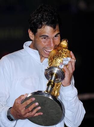 Rafael Nadal of Spain poses with the trophy during the awarding ceremony after the men s singles final in Qatar Open tennis tournament, Jan. 4, 2014. Nadal won 2-1 to claim the champion. (Xinhua Chen Shaojin) (SP)QATAR-DOHA-TENNIS-MEN 