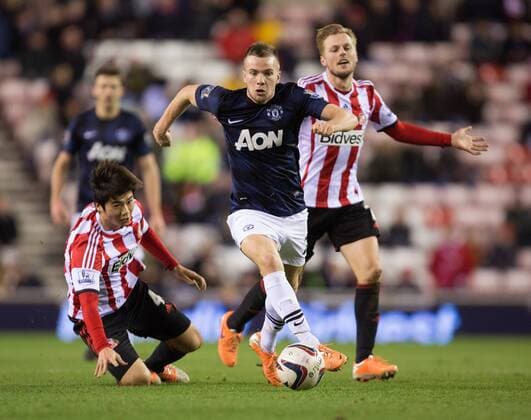 Tom Cleverley of Manchester United escapes the attention of Ki Sung-Yueng and Sebastian Larsson of Sunderland - AFC Sunderland vs. Manchester United (ManU) - Capital One Cup Semi Final First Leg - Stadium of Light - Sunderland - 07 01 2014 EDITORIAL USE ONLY. No use with unauthorised audio, video, data, fixture lists, club league logos or live services. Online in-match use limited to 120 images, no video emulation. No use in betting, games or single club league player publications.