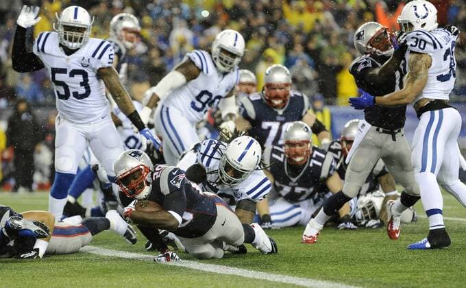 New England Patriots running back LeGarrette Blount (29) scores on a 2-yard carry against the Indianapolis Colts in the first quarter of the AFC Divisional Playoff at Gillette Stadium in Foxboro, Massachusetts on January 11, 2014.  BOS2014011101
