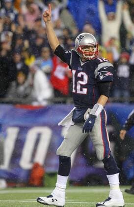 New England Patriots quarterback Tom Brady (12) points his finger in the air after a three-yard touchdown run by running back Stevan Ridley (not picuted) in the third quarter against the Indianapolis Colts in the AFC Divisional Playoff game at Gillette Stadium in Foxboro, Massachusetts on January 11, 2014. The Patriots defeated the Colts 43-22.  BOS2014011107