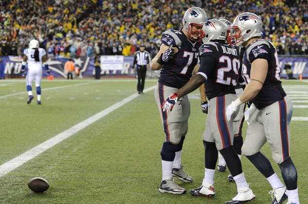 New England Patriots running back LeGarrette Blount (29) is congratulated by Patriots tackle Nate Solder (77) after Blount scored on a 73-yard touchdown in the fourth quarter against the Indianapolis Colts in the AFC Divisional Playoff game at Gillette Stadium in Foxboro, Massachusetts on January 11, 2014. The Patriots defeated the Colts 43-22.  BOS2014011109