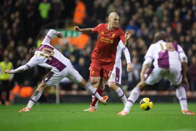 Martin Skrtel of Liverpool skips past an outstretched leg of Andreas Weimann of Aston Villa - Liverpool FC vs. Aston Villa - Barclays Premier League - Anfield - Liverpool - 18 01 2014 Pic PhilipxOldham Sportimage EDITORIAL USE ONLY. No use with unauthorised audio, video, data, fixture lists, club league logos or live services. Online in-match use limited to 120 images, no video emulation. No use in betting, games or single club league player publications.