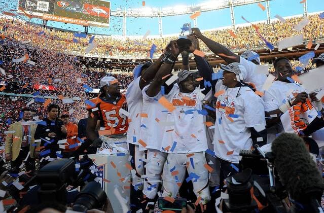 Jan. 18, 2014 - Denver, CO, USA - Broncos players celebrate with the AFC Championship Trophy at Sports Authority Field at Mile High in Denver on Sunday, Jan. 19, 2014. The Denver Broncos defeated the New England Patriots, 26-16. BRONCOS PATRIOTS - ZUMAm67