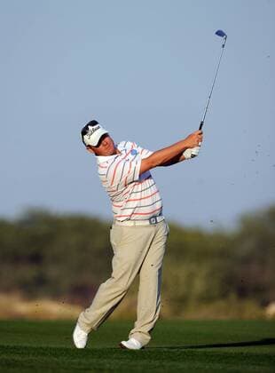 (140122) -- DOHA, Jan. 22, 2014 (Xinhua) -- George Coetzee of South Africa hits the ball during the first day match at Qatar Masters in Doha, Qatar, Jan. 22, 2014. (Xinhua Chen Shaojin) (SP)QATAR-DOHA-GOLF-QATAR MASTERS 