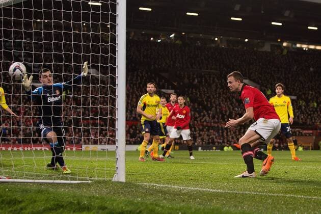 Jonny Evans of Manchester United opens the scoring with the first goal - Manchester United vs. Sunderland - Capital One Cup Semi Final Second Leg - Old Trafford - Manchester - 22 01 2014 Pic Philip Oldham Sportimage EDITORIAL USE ONLY. No use with unauthorised audio, video, data, fixture lists, club league logos or live services. Online in-match use limited to 120 images, no video emulation. No use in betting, games or single club league player publications.