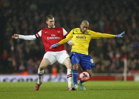 Arsenal s Per Mertesacker tussles with Coventry s Leon Clarke Arsenal vs Coventry City - FA Cup Fourth Round - Emirates Stadium - London - England - 24 01 2014 - Pic David Klein Sportimage EDITORIAL USE ONLY. No use with unauthorised audio, video, data, fixture lists, club league logos or live services. Online in-match use limited to 120 images, no video emulation. No use in betting, games or single club league player publications.