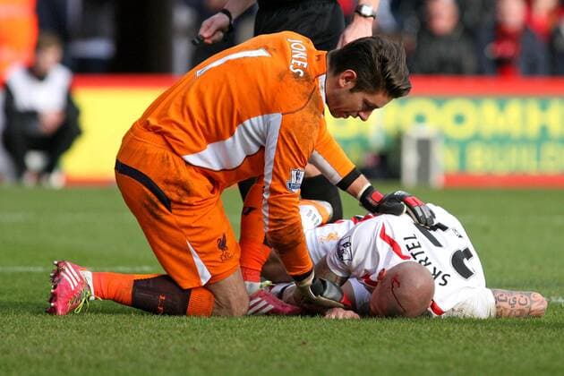 Football - 2013 2014 FA Cup - Fourth Round: AFC Bournemouth vs. FC Liverpool Martin Skrtel of Liverpool lies in the penalty area with a head wound at Dean Court The Goldsands Stadium - 