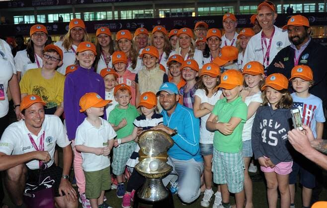 Sergio Garcia of Spain holds the winner s trophy with fans after the final round of the Commercial Bank Qatar Masters at the Doha Golf Club in Doha, Qatar, Jan. 25, 2014. Garcia claimed the title after he birdied the third extra hole to beat Finland s Mikko Ilonen in a playoff. (Xinhua Chen Shaojin) (SP)QATAR-DOHA-GOLF-MASTERS 