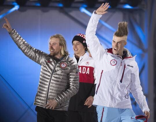 Slopestyle gold medalist Sage Kotsenburg of America (L), bronze medalist Mark McMorris of Canada (center) and silver medalist Staale Sandbeach of Norway wave during their victory ceremony at the Sochi 2014 Winter Olympics on February 7, 2014 in Sochi, Russia.  OLY20140208333