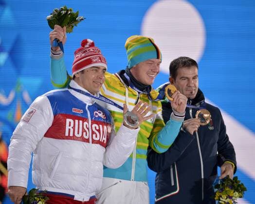Russia s Albert Demchenko (L-R), Germany s Felix Loch and Italy s Armin Zöggeler hold their silver, gold and bronze medals during the victory ceremony for men s luge singles at the Sochi 2014 Winter Olympics on February 10, 2014 in Sochi, Russia.  OLY20140210147