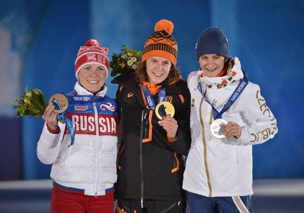 The Czech Republic s Martina Sablikova (R-L), the Netherland s Ireen Wüst and Russia s Olga Graf stand with their silver, gold and bronze medals during the victory ceremony for ladies 3000M speed skating at the Sochi 2014 Winter Olympics on February 10, 2014 in Sochi, Russia.  OLY20140210164