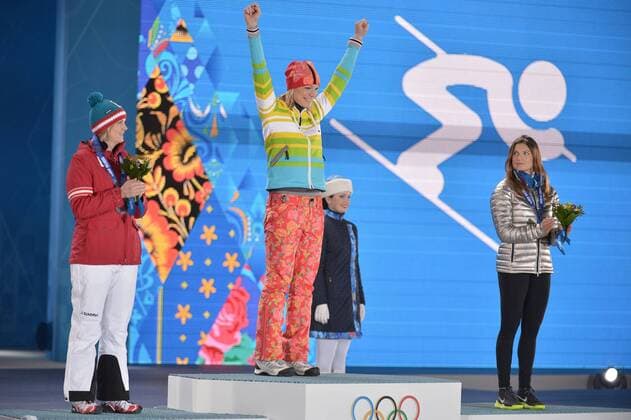 Austria s Nicole Hosp (L), and United States Julia Mancuso (R) watch as Germany s Maria HÖFL RIESCH is announced as the gold medalist during the victory ceremony for alpine ladies super combined at the Sochi 2014 Winter Olympics on February 10, 2014 in Sochi, Russia. Mancuso won bronze while Hosp won silver.  OLY20140210177