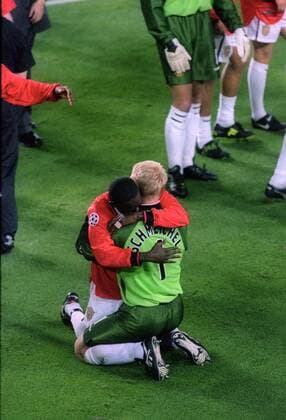 Dwight Yorke and Peter Peter Schmeichel embrace at the end of the match - UEFA Champions League final 1999 - Manchester United vs Bayern Munich at the Now Camp Stadium, Barcelona, Spain - 26th May 1999 Pictures Simon Bellis Sportimage EDITORIAL USE ONLY. No use with unauthorised audio, video, data, fixture lists, club league logos or live services. Online in-match use limited to 120 images, no video emulation. No use in betting, games or single club league player publications.