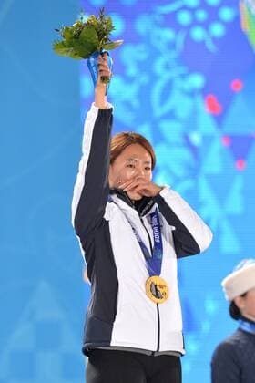 Gold medalist, South Korea s Sang Hwa Lee, celebrates during the victory ceremony for the ladies speed skating 500m at the Sochi 2014 Winter Olympics on February 12, 2014 in Sochi, Russia.  OLY20140212345